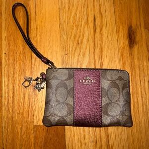 Coach wristlet with magenta stripe and keychains